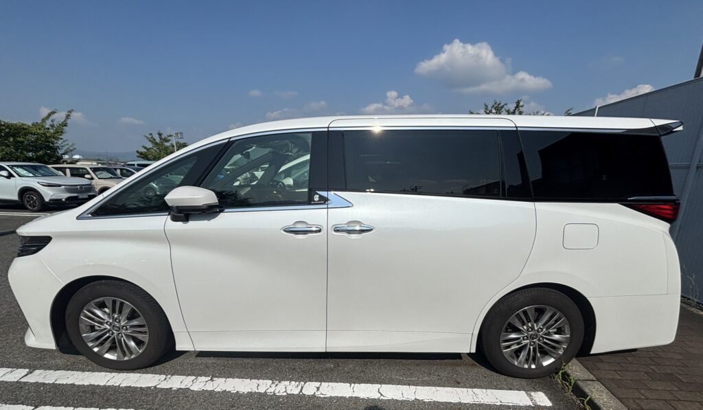 駐車場に停めた白い40系アルファードの左側面とボディサイズ